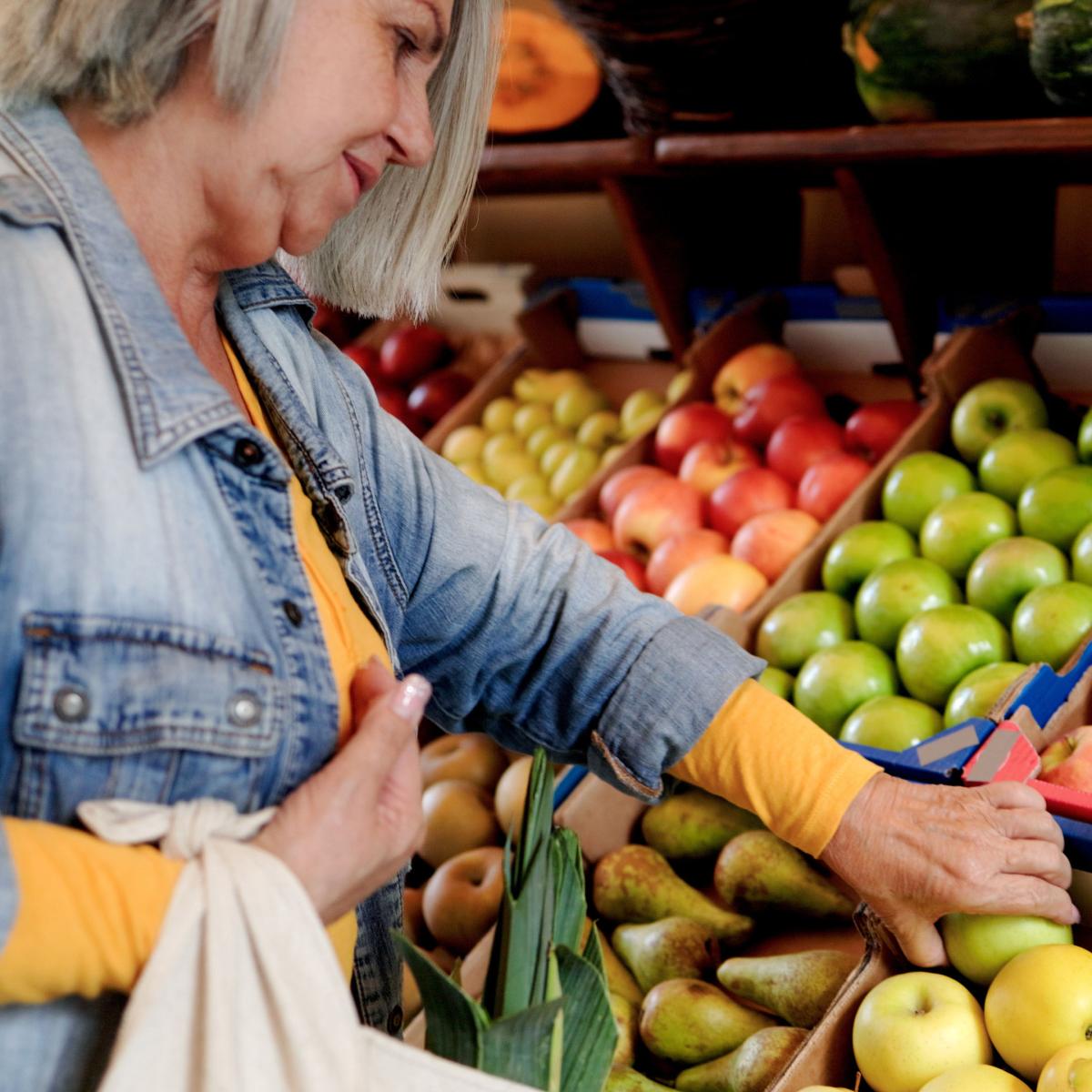 Older adult choosing fruit at a Farmers Market